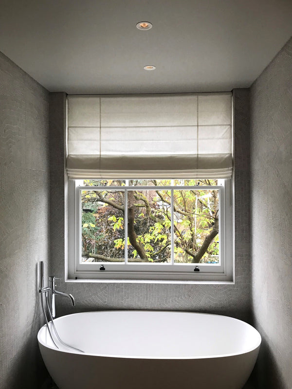 roman blinds on a sash window in a small bathroom